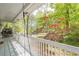 Inviting porch with a swing chair providing a relaxing view of the landscaped yard at 2101 Kinridge Rd, Marietta, GA 30062