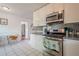 Modern kitchen featuring white cabinets, stainless steel appliances, and an adjacent eating area at 2101 Kinridge Rd, Marietta, GA 30062