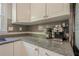 Granite countertops and stainless appliances enhance this kitchen with tile backsplash and sleek design at 2101 Kinridge Rd, Marietta, GA 30062