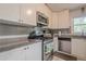 Updated kitchen features stainless steel appliances, granite counters, and a stylish tile backsplash at 2101 Kinridge Rd, Marietta, GA 30062