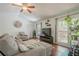 Cozy living room with vaulted ceilings, ceiling fan, hardwood floors and large windows offering natural light at 2101 Kinridge Rd, Marietta, GA 30062