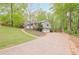 Side view showing driveway, garage and mature trees at 2101 Kinridge Rd, Marietta, GA 30062