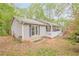 Side view of a gray home, showcasing its garden plot and outdoor space at 2101 Kinridge Rd, Marietta, GA 30062