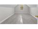 Attic space with neutral carpet, a small window, and natural lighting at 2443 High Meadows Ct, Conyers, GA 30094