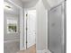 Bathroom featuring a shower, tile flooring, and view into bedroom at 2443 High Meadows Ct, Conyers, GA 30094