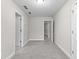 Empty room featuring neutral carpet, two doorways, and natural lighting at 2443 High Meadows Ct, Conyers, GA 30094