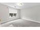 An empty bedroom filled with neutral carpet, a large window and natural lighting at 2443 High Meadows Ct, Conyers, GA 30094