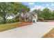 Lovely home featuring a spacious driveway, well-kept lawn, and mature shade trees at 2443 High Meadows Ct, Conyers, GA 30094