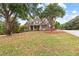 Attractive home with beautiful landscaping, mature trees, and a well-maintained lawn at 2443 High Meadows Ct, Conyers, GA 30094