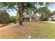 Beautiful home with a well-manicured lawn and mature trees, creating a serene setting at 2443 High Meadows Ct, Conyers, GA 30094