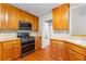 Traditional kitchen featuring wood cabinets, modern appliances, and hardwood floors at 2443 High Meadows Ct, Conyers, GA 30094