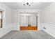 Bright, open living room with wainscoting, neutral walls, and plush gray carpet, perfect for modern living at 2443 High Meadows Ct, Conyers, GA 30094
