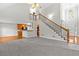 Open-concept living space with stairs to the second floor, carpeted floors, and hardwood flooring at 2443 High Meadows Ct, Conyers, GA 30094