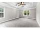 Spacious bedroom featuring tray ceiling, new carpet, and large windows at 2443 High Meadows Ct, Conyers, GA 30094