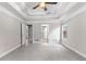 Spacious bedroom with tray ceiling, new carpet, large window, and several entryways at 2443 High Meadows Ct, Conyers, GA 30094