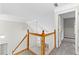 View of the staircase with wood railing and carpeted steps at 2443 High Meadows Ct, Conyers, GA 30094