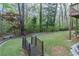 Landscaped backyard with a small bridge leading to a wooded area at 275 Sageglen Rd, Lawrenceville, GA 30044