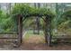 Landscaped backyard featuring an arbor with a bench swing at 275 Sageglen Rd, Lawrenceville, GA 30044