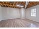 Unfinished basement features an exposed ceiling, wood-look flooring, and a single window at 275 Sageglen Rd, Lawrenceville, GA 30044