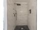 Tiled shower with black and white herringbone floor and a built in soap nook at 275 Sageglen Rd, Lawrenceville, GA 30044
