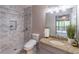 Well-lit bathroom features a granite vanity, step-in shower, and tiled flooring at 275 Sageglen Rd, Lawrenceville, GA 30044