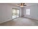 Bedroom features carpet, ceiling fan, and a sliding glass door to the screened porch at 275 Sageglen Rd, Lawrenceville, GA 30044