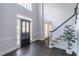 Bright entryway features a black front door with decorative glass and hardwood floors leading to a staircase at 275 Sageglen Rd, Lawrenceville, GA 30044