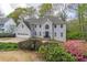 Charming two-story home with a manicured lawn, an attached garage, and mature trees at 275 Sageglen Rd, Lawrenceville, GA 30044