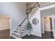 Bright foyer with stairs with black handrail, plant, and dark hardwood floors at 275 Sageglen Rd, Lawrenceville, GA 30044
