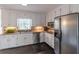 Bright kitchen features white cabinets, stainless steel appliances, and granite countertops at 275 Sageglen Rd, Lawrenceville, GA 30044