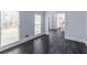 Cozy living room with hardwood floors, large windows, and a view into the home's entryway at 275 Sageglen Rd, Lawrenceville, GA 30044