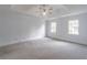 Spacious main bedroom with a ceiling fan and large windows with great lighting at 275 Sageglen Rd, Lawrenceville, GA 30044