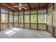 Spacious screened porch featuring wood framing, ceiling fan, and privacy shades at 275 Sageglen Rd, Lawrenceville, GA 30044