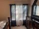 Bedroom with dark wood dresser, mirror and neutral curtains at 6438 Wedgeview Dr, Tucker, GA 30084