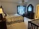 Well-lit bedroom featuring a comfortable bed, a dresser, and an ensuite bathroom at 6438 Wedgeview Dr, Tucker, GA 30084