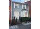 Charming two-story townhouse featuring classic siding, a decorative bay window, and landscaped front yard at 6438 Wedgeview Dr, Tucker, GA 30084