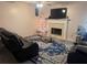Inviting living room with a cozy fireplace, neutral walls, and stylish area rug at 6438 Wedgeview Dr, Tucker, GA 30084