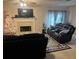 Inviting living room with a cozy fireplace, neutral walls, and stylish area rug at 6438 Wedgeview Dr, Tucker, GA 30084