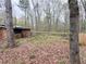 View of a fenced backyard with a shed and trees at 110 N River Rd, Mcdonough, GA 30252
