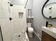 Modern bathroom with a walk-in shower featuring white subway tiles, a river rock base and sleek fixtures at 110 N River Rd, Mcdonough, GA 30252
