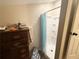 Small bathroom featuring a stand-up shower and a wooden dresser at 110 N River Rd, Mcdonough, GA 30252