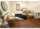Bedroom showcasing a cozy bed, mirrors, wicker furniture, and a decorative plant, offering a relaxing space at 110 N River Rd, Mcdonough, GA 30252