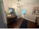 Entryway with hardwood floors, a vintage console table, a decorative mirror and a front door with glass inserts at 110 N River Rd, Mcdonough, GA 30252