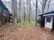 Exterior view of cabin and outbuilding, showcasing wood siding and natural surroundings at 110 N River Rd, Mcdonough, GA 30252