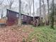 Exterior side view of home with wooden siding, wooden stairs, and a lush ivy-covered yard at 110 N River Rd, Mcdonough, GA 30252