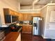Efficient kitchen featuring light oak cabinets, granite countertops, and stainless appliances at 110 N River Rd, Mcdonough, GA 30252