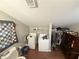 Laundry area with a washer, dryer, toilet, closet, and quilt at 110 N River Rd, Mcdonough, GA 30252
