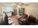 Cozy living area with a ceiling fan, television, wood floors, and furniture at 110 N River Rd, Mcdonough, GA 30252