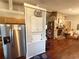 Open-concept home design with living room with hardwood floors, stone fireplace, and modern appliances at 110 N River Rd, Mcdonough, GA 30252