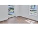 Bedroom featuring two large windows with outside views and wood-style flooring at 2000 Grove Ave, East Point, GA 30344
